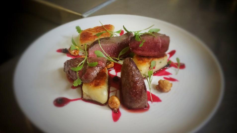 Roast wood pigeon with herb dumplings, elderberry syrup and candied cobnuts